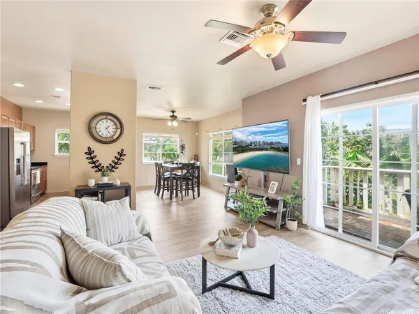 a living room with furniture a fireplace and a chandelier