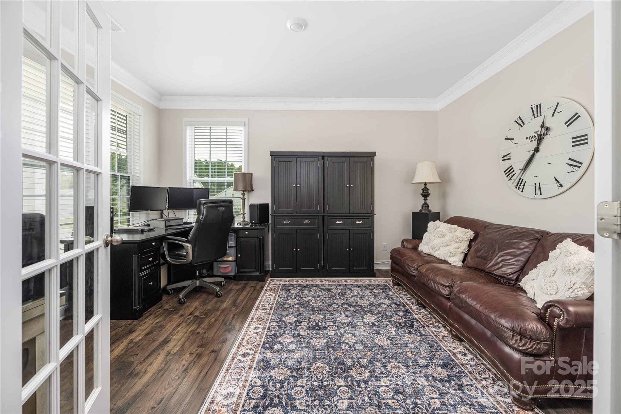 121 Rhuidean Court Troutman, NC 28166 - Photo 11 of 44 a living room with furniture a flat screen tv and a refrigerator