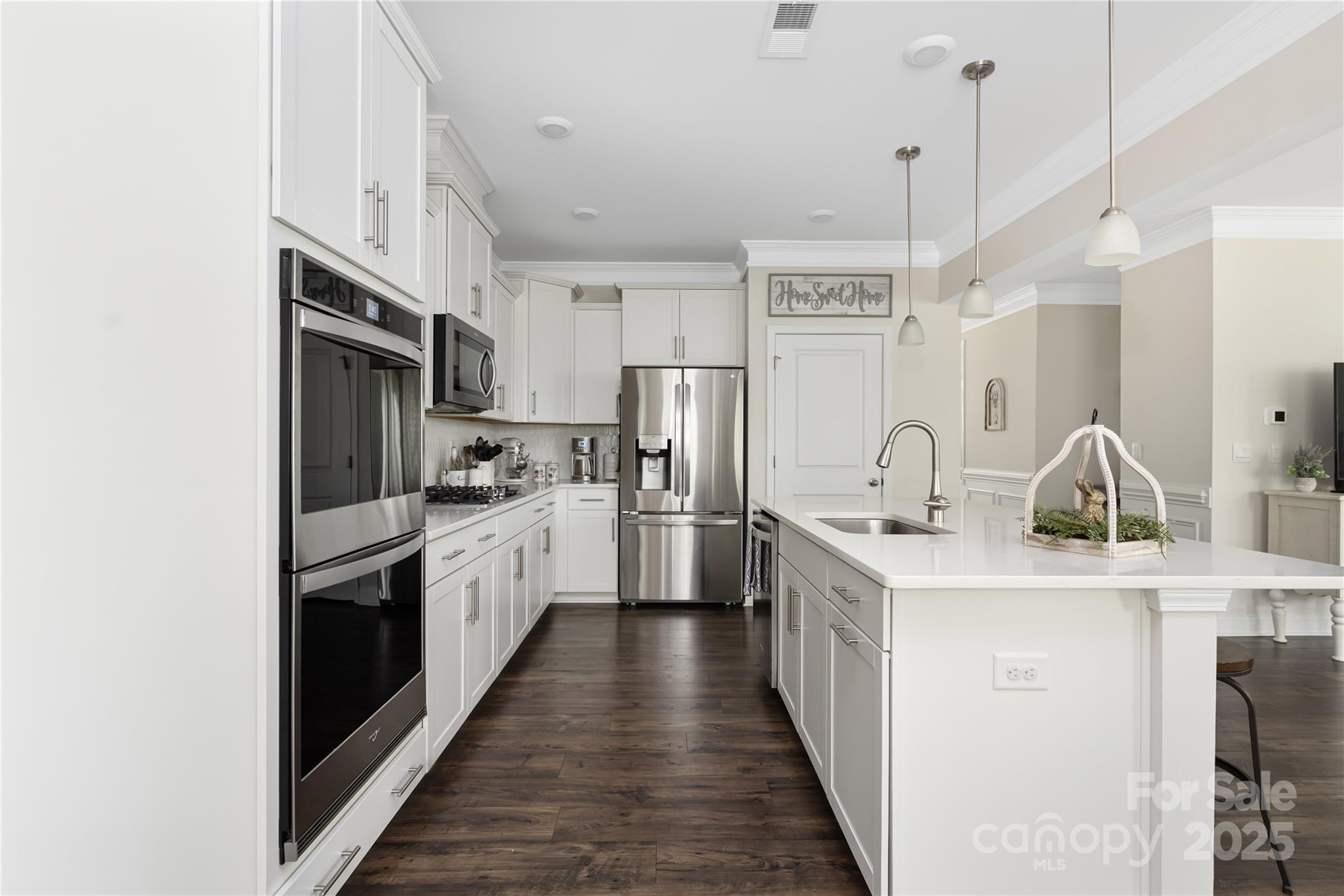 121 Rhuidean Court Troutman, NC 28166 - Photo 14 of 44 a kitchen with stainless steel appliances a sink stove and refrigerator