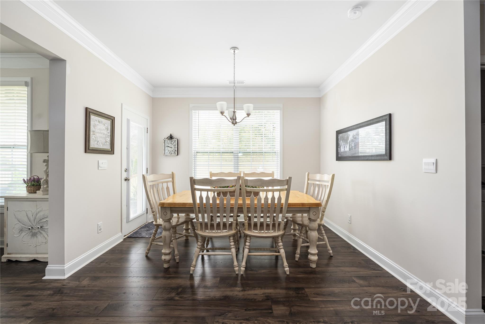 121 Rhuidean Court Troutman, NC 28166 - Photo 15 of 44 a view of a dining room with furniture window and wooden floor