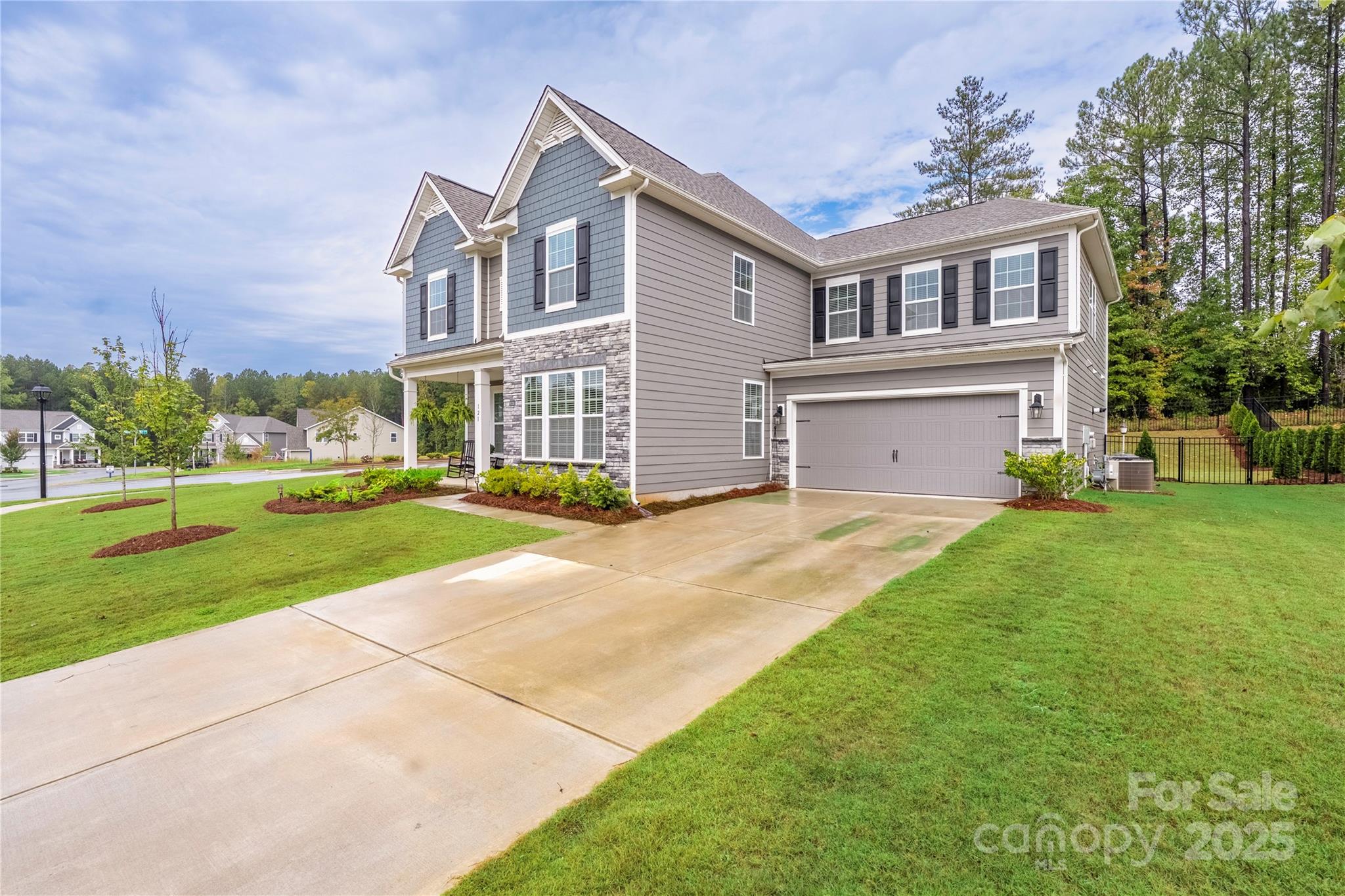 121 Rhuidean Court Troutman, NC 28166 - Photo 2 of 44 a front view of a house with a yard and trees