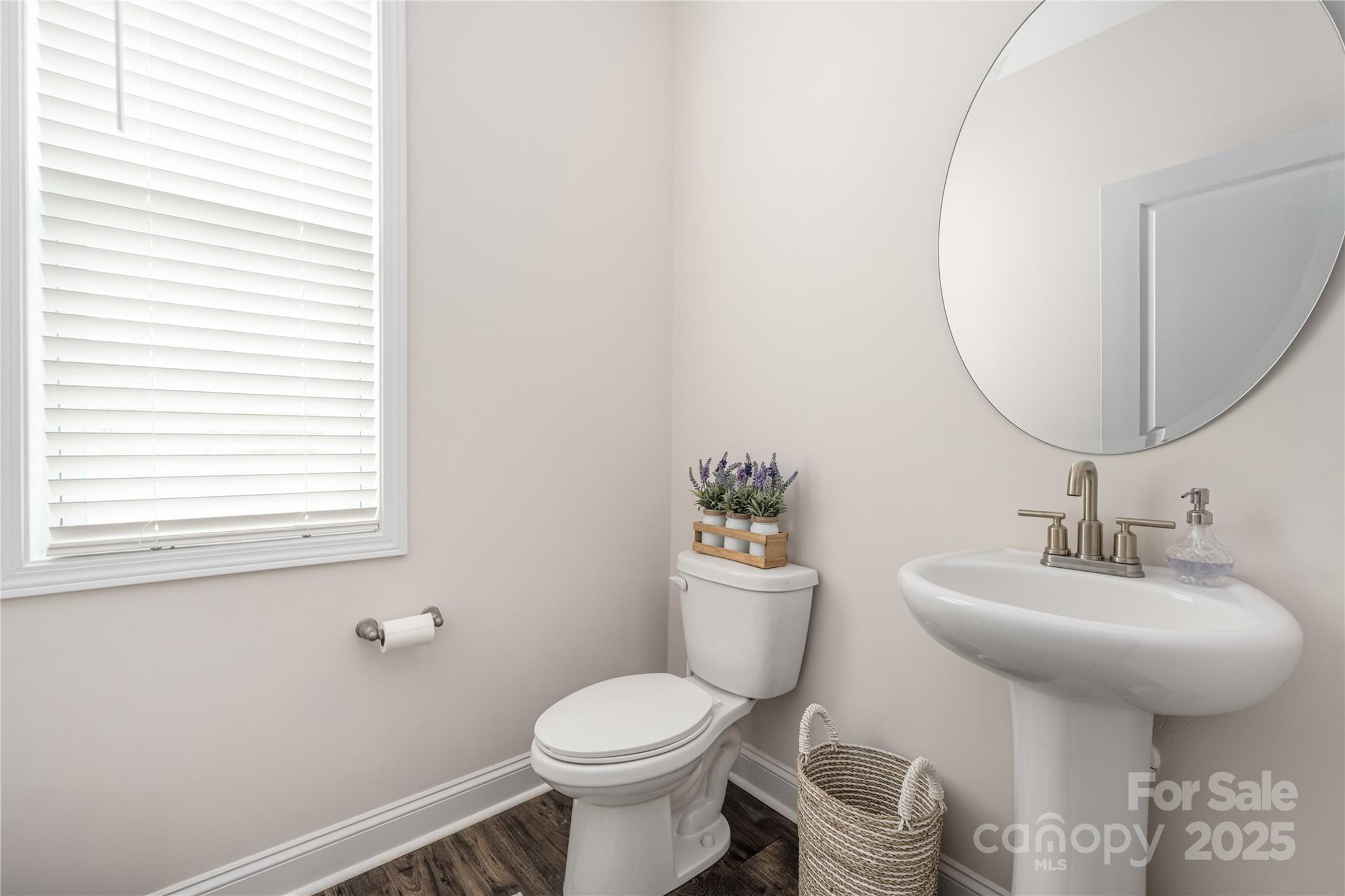 121 Rhuidean Court Troutman, NC 28166 - Photo 21 of 44 a bathroom with a toilet sink and mirror