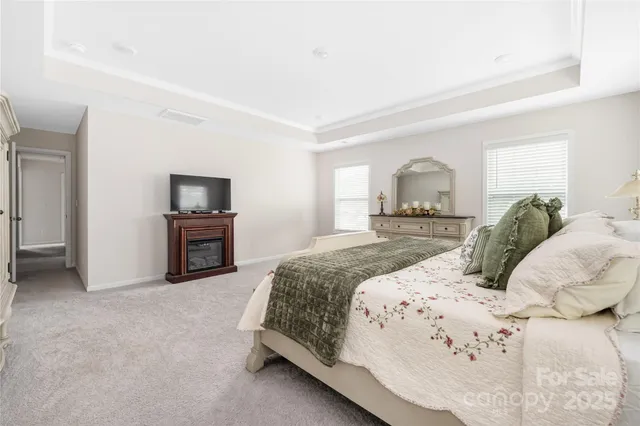 a bedroom with a bed and a television