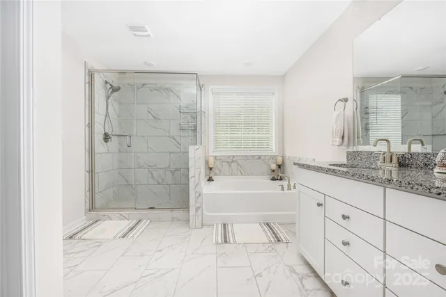 a bathroom with a granite countertop sink a toilet and bathtub
