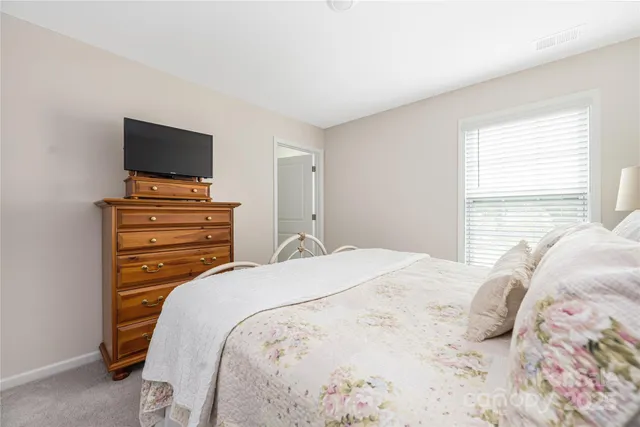a bedroom with a bed and flat screen tv