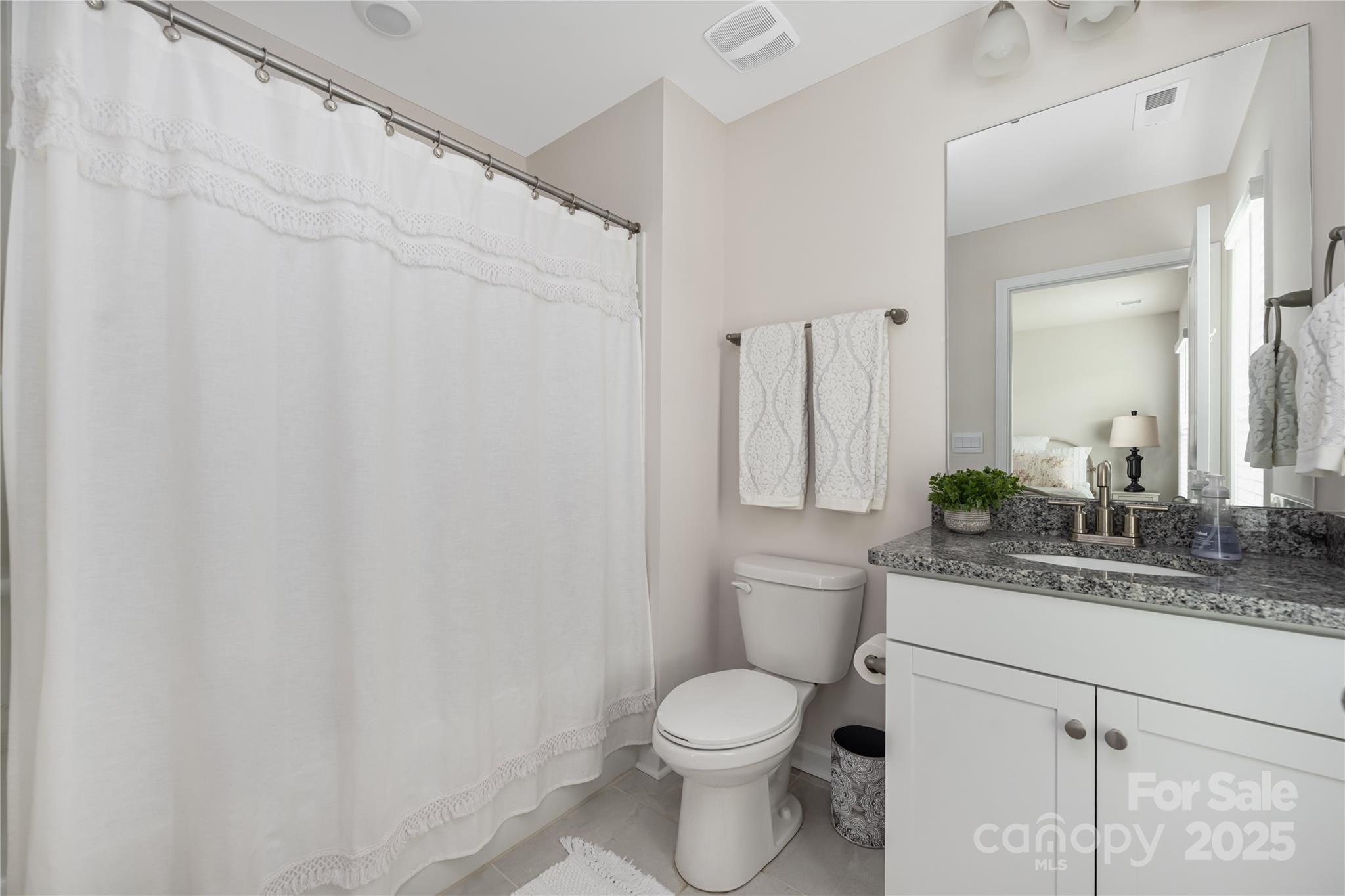 121 Rhuidean Court Troutman, NC 28166 - Photo 31 of 44 a bathroom with a granite countertop sink and a mirror