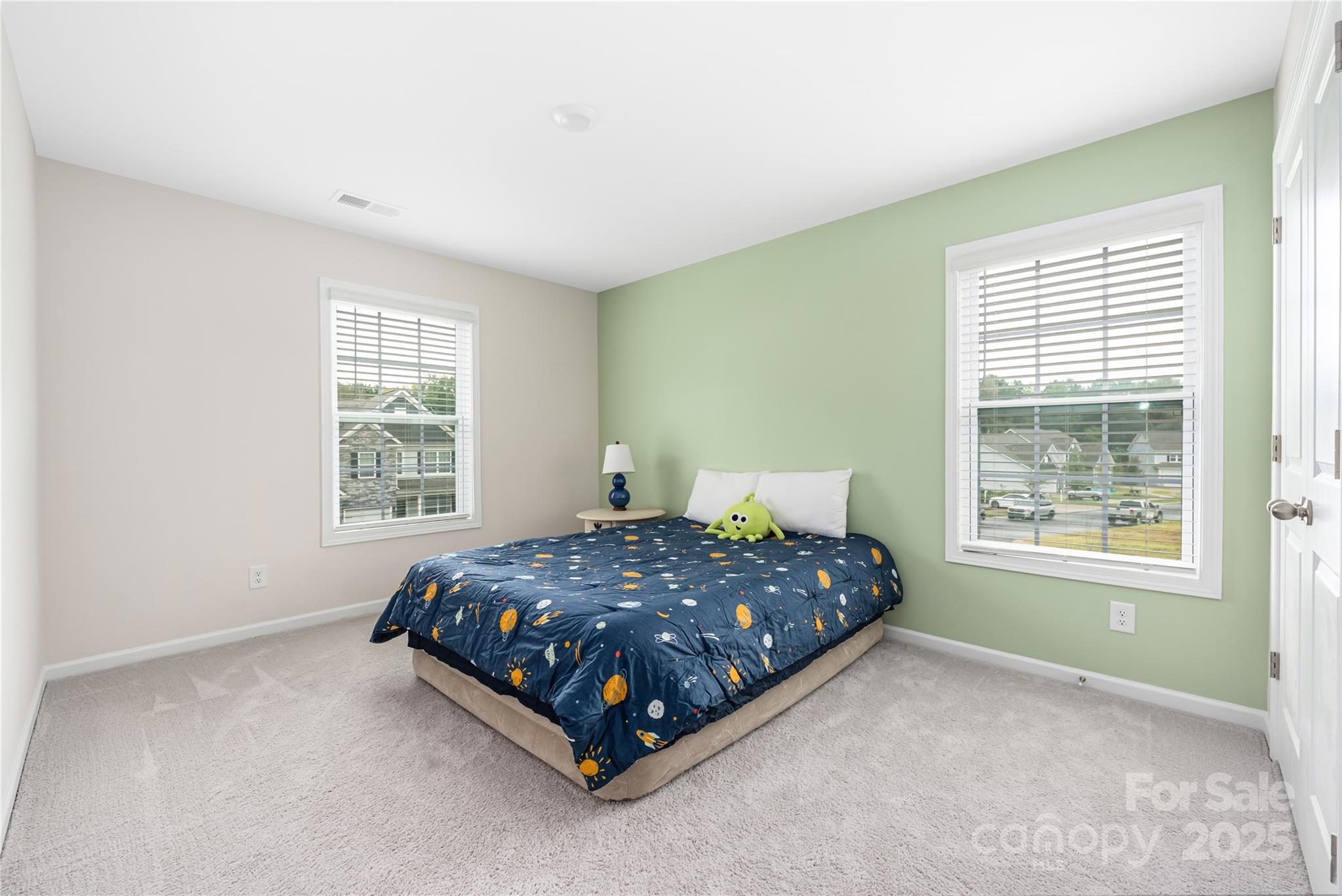 121 Rhuidean Court Troutman, NC 28166 - Photo 35 of 44 a bedroom with a bed lamp and window