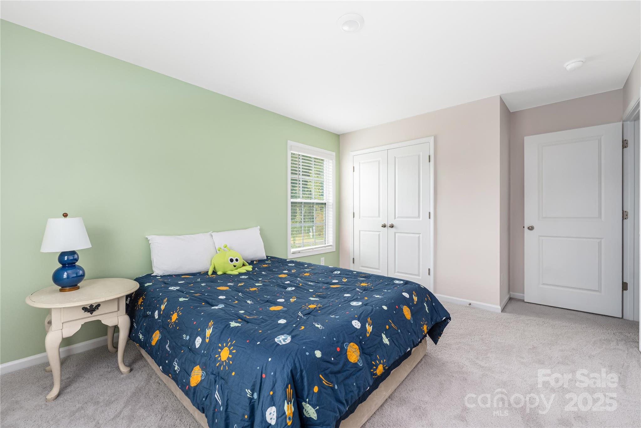 121 Rhuidean Court Troutman, NC 28166 - Photo 36 of 44 a large bed sitting in a bedroom next to a window and a table