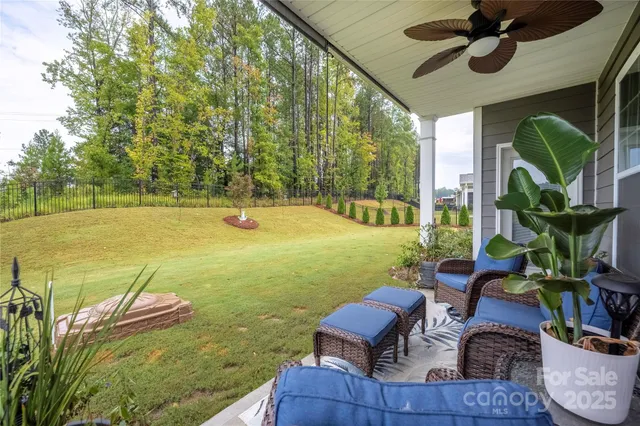 a view of a patio with table and chairs potted plants with swimming pool