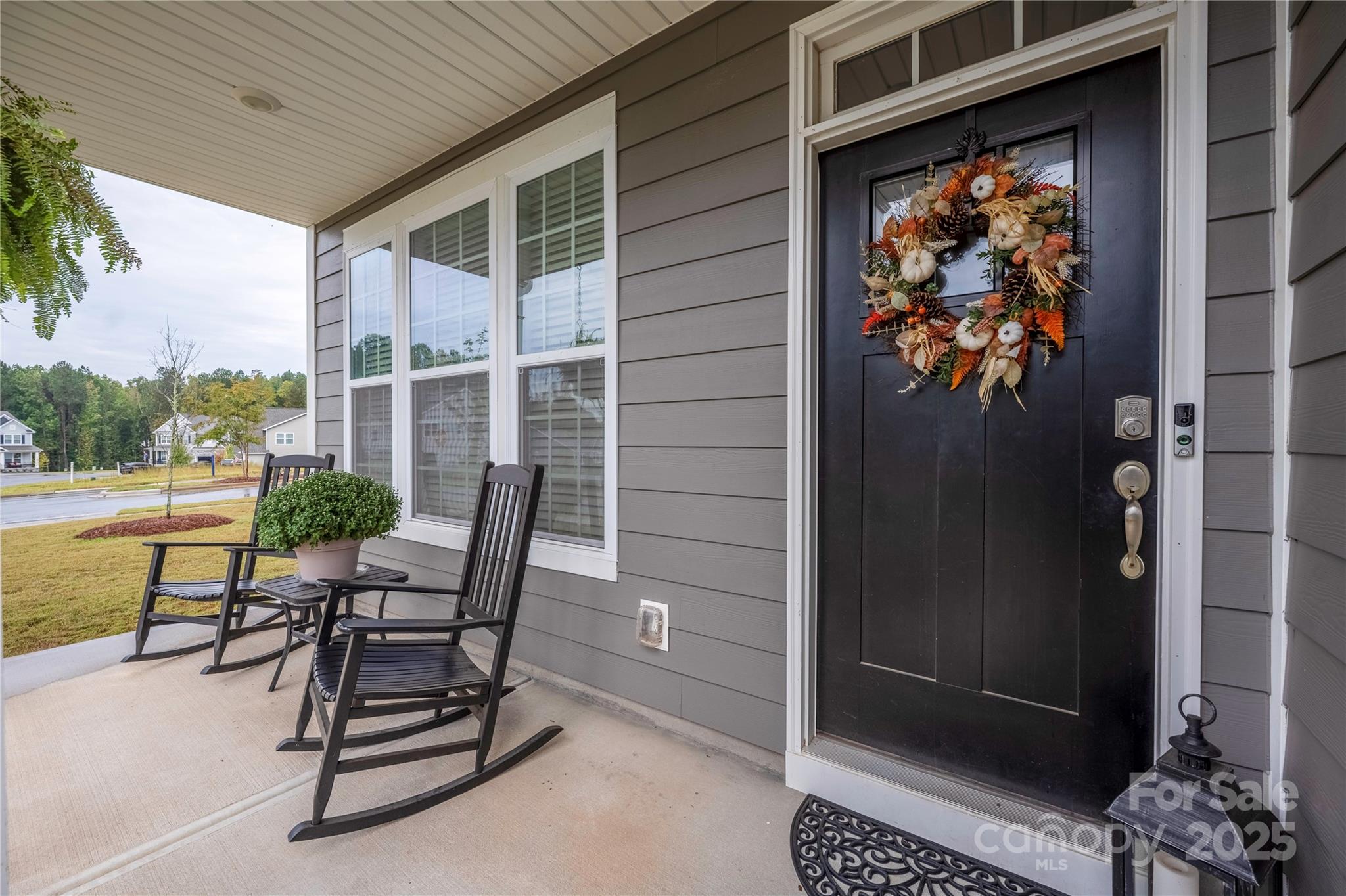 121 Rhuidean Court Troutman, NC 28166 - Photo 5 of 44 a view of a patio with table and chairs and potted plants