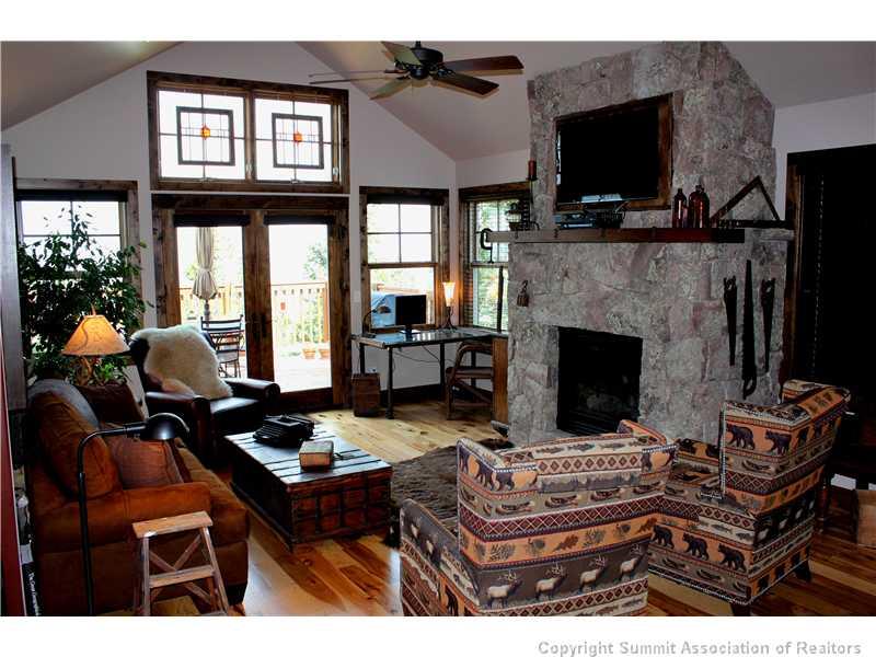 75 Uncle Sam Lode Road Breckenridge, CO 80424 - Photo 5 of 16 a living room with furniture a flat screen tv and a fireplace