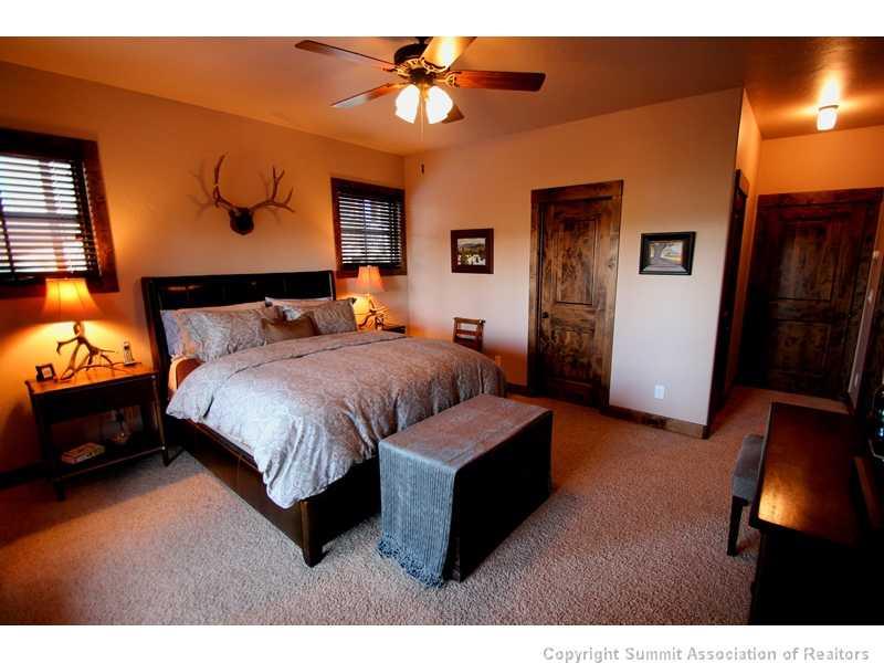 75 Uncle Sam Lode Road Breckenridge, CO 80424 - Photo 9 of 16 a bedroom with a bed and a chandelier