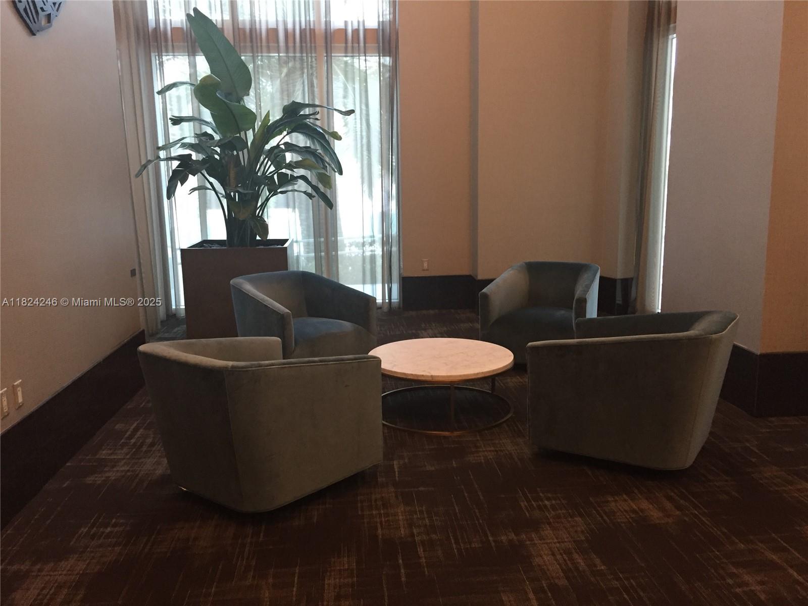 951 Brickell Avenue, Unit 3703 Miami, FL 33131 - Photo 22 of 34 a living room with furniture and a potted plant