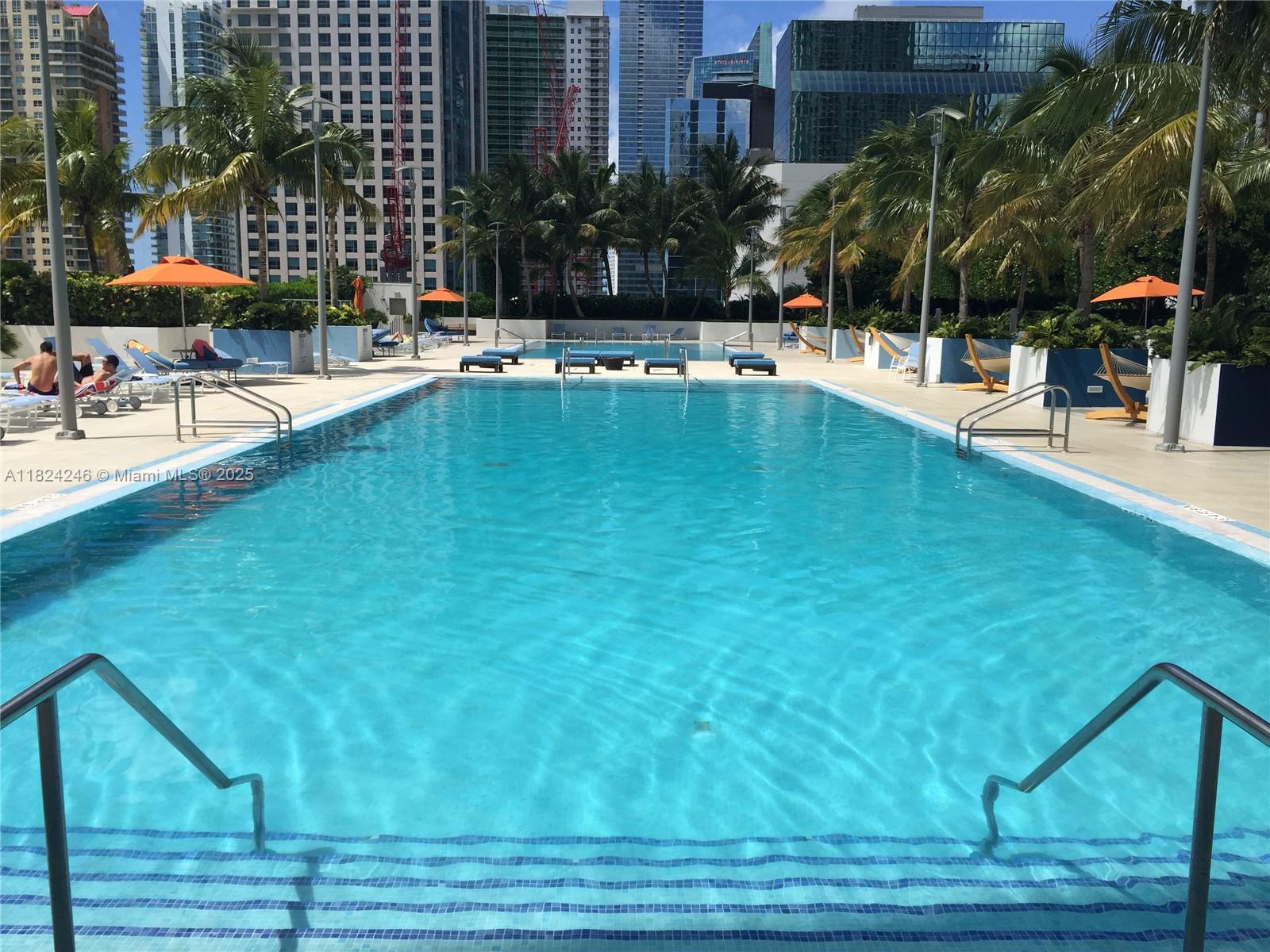 951 Brickell Avenue, Unit 3703 Miami, FL 33131 - Photo 29 of 34 a view of a swimming pool with lounge chairs