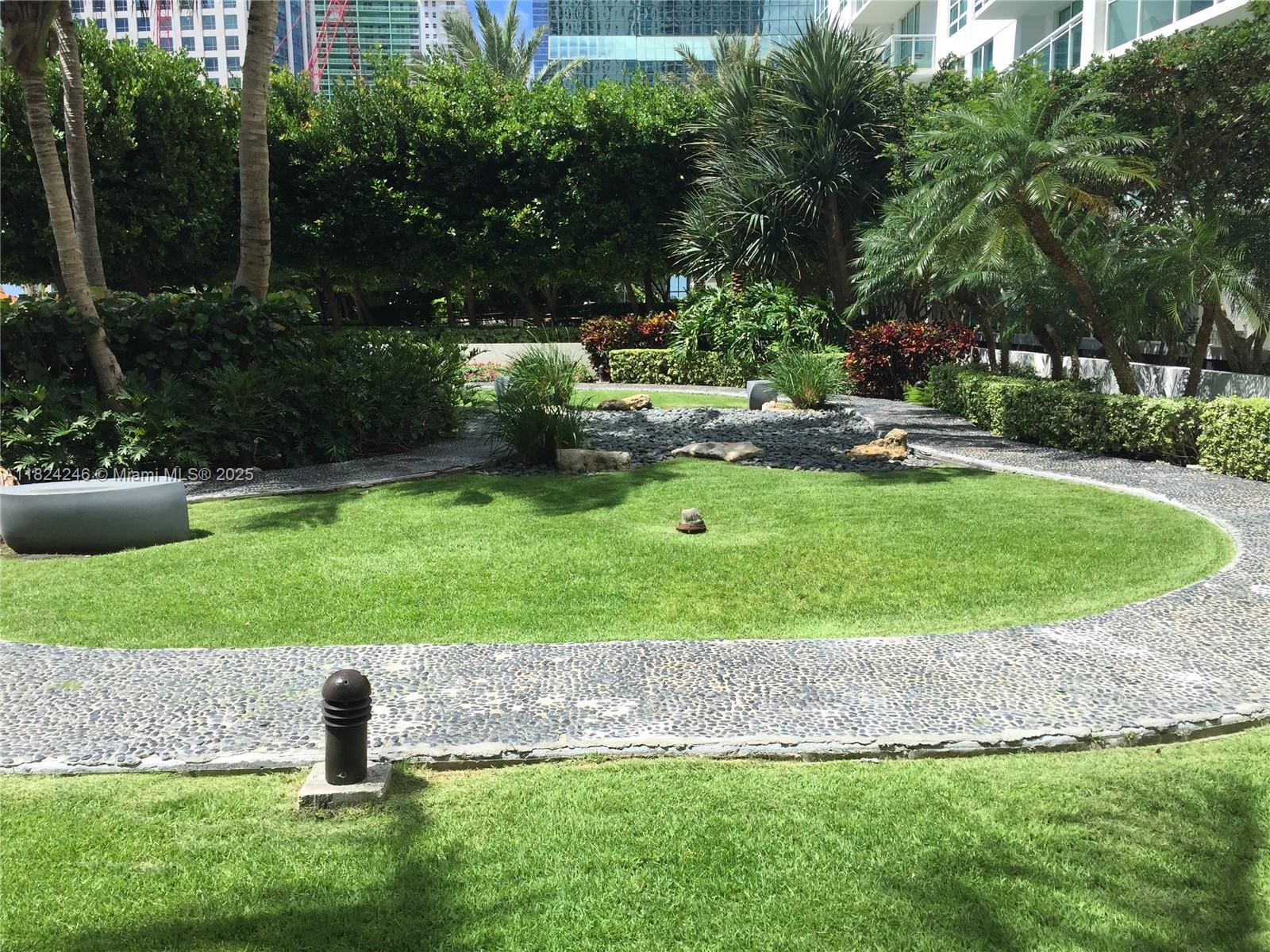 951 Brickell Avenue, Unit 3703 Miami, FL 33131 - Photo 31 of 34 a view of a garden with a fountain