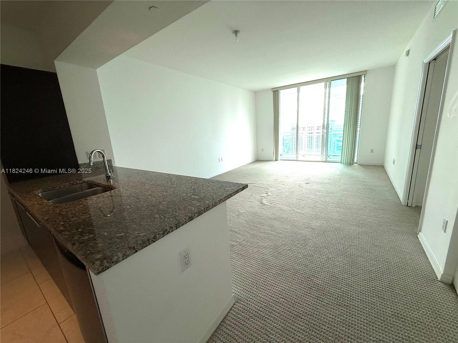 951 Brickell Avenue, Unit 3703 Miami, FL 33131 - Photo 4 of 34 a kitchen with a granite countertop sink and a granite counter tops