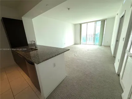 a view of kitchen island with windows