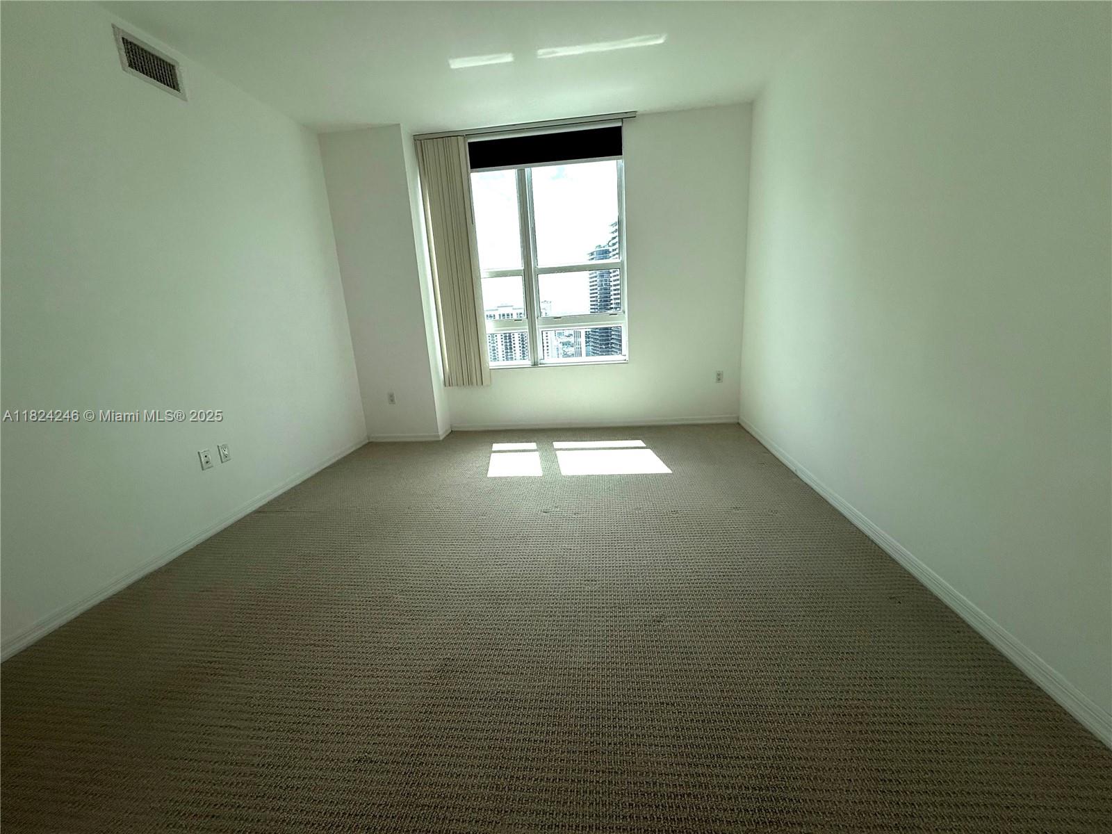 951 Brickell Avenue, Unit 3703 Miami, FL 33131 - Photo 10 of 34 an empty room with a window