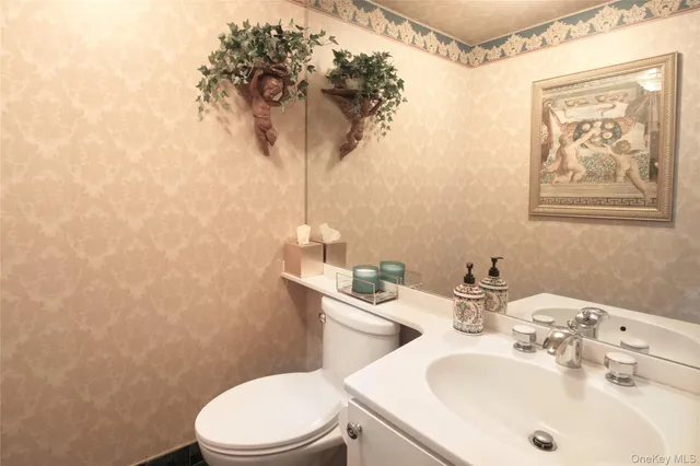 a bathroom with a sink a toilet and a mirror