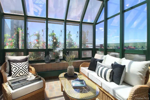 a living room with furniture and a floor to ceiling window