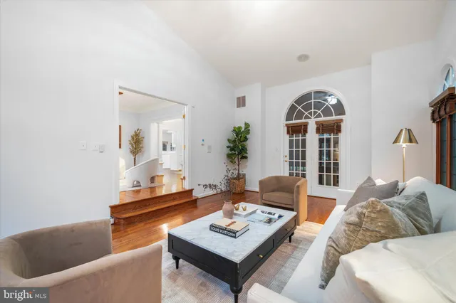 a living room with furniture a large window and a fireplace