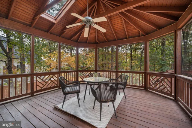 a kitchen with stainless steel appliances granite countertop a stove a oven with a dining table and chairs