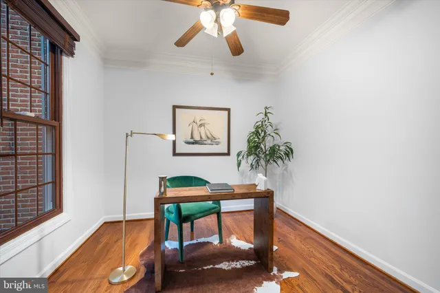 a view of a hallway with wooden floor and windows