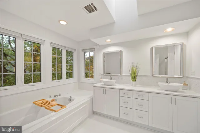 a bathroom with a shower sink vanity mirror and toilet