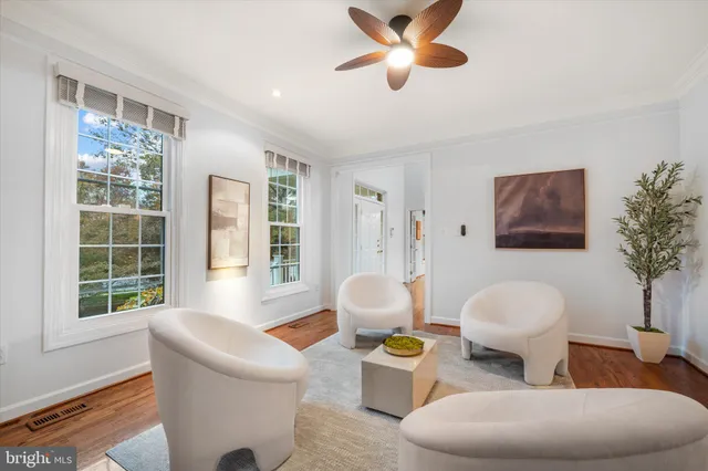 a large kitchen with stainless steel appliances a sink dishwasher a refrigerator a stove and white cabinets with wooden floor