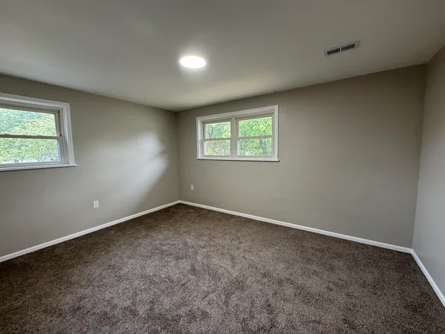 a view of staircase with white walls