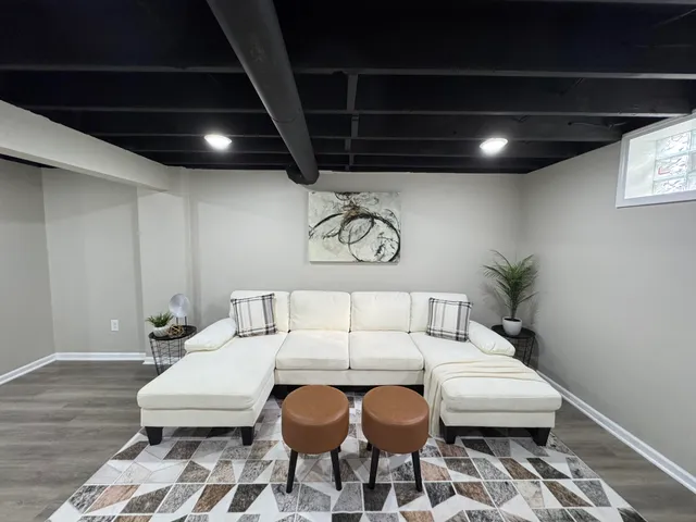a living room with furniture and a chandelier
