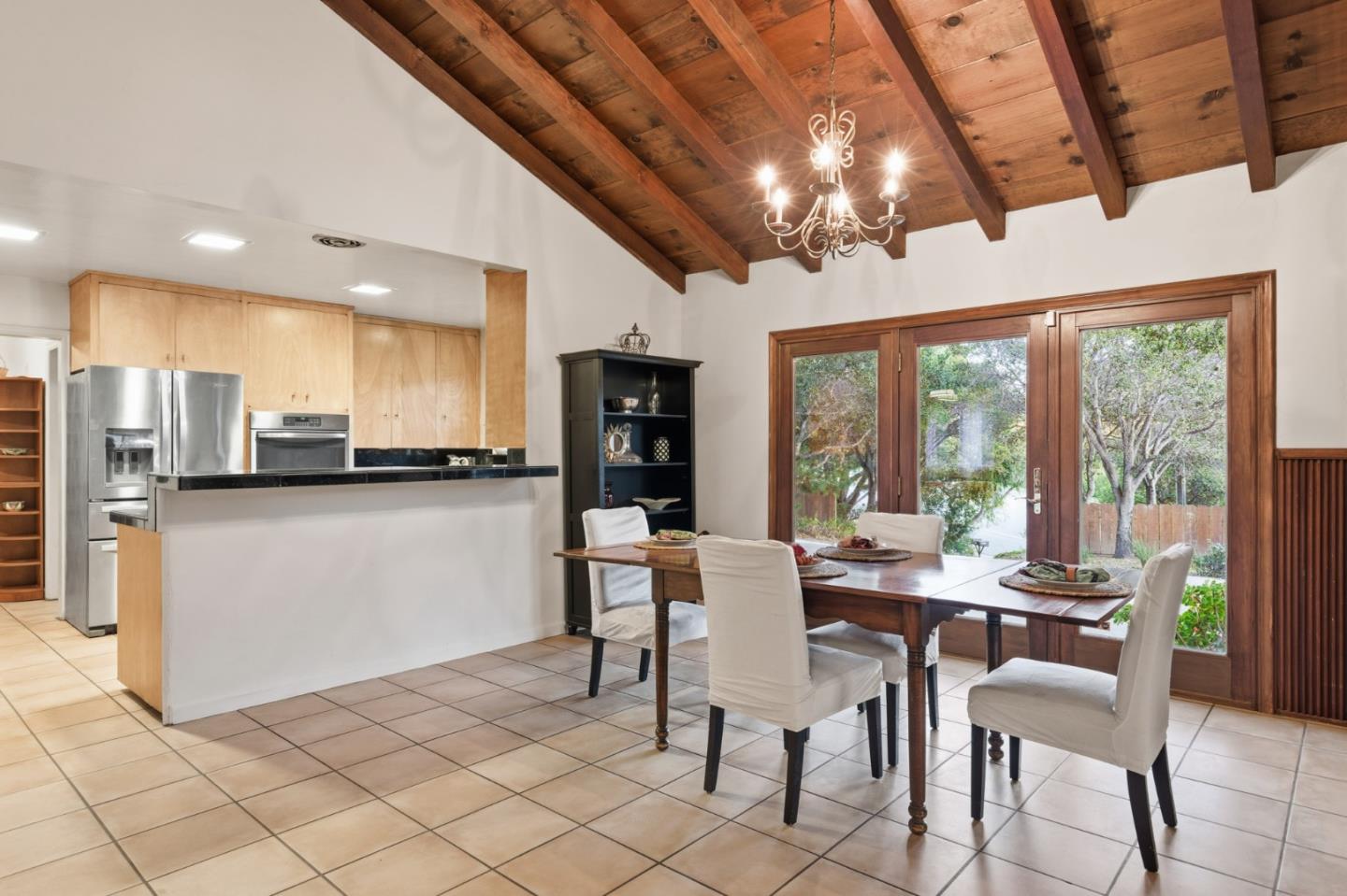 9805 Carmel Valley Road Carmel, CA 93923 - Photo 15 of 35 a view of a dining room with furniture large window and chandelier