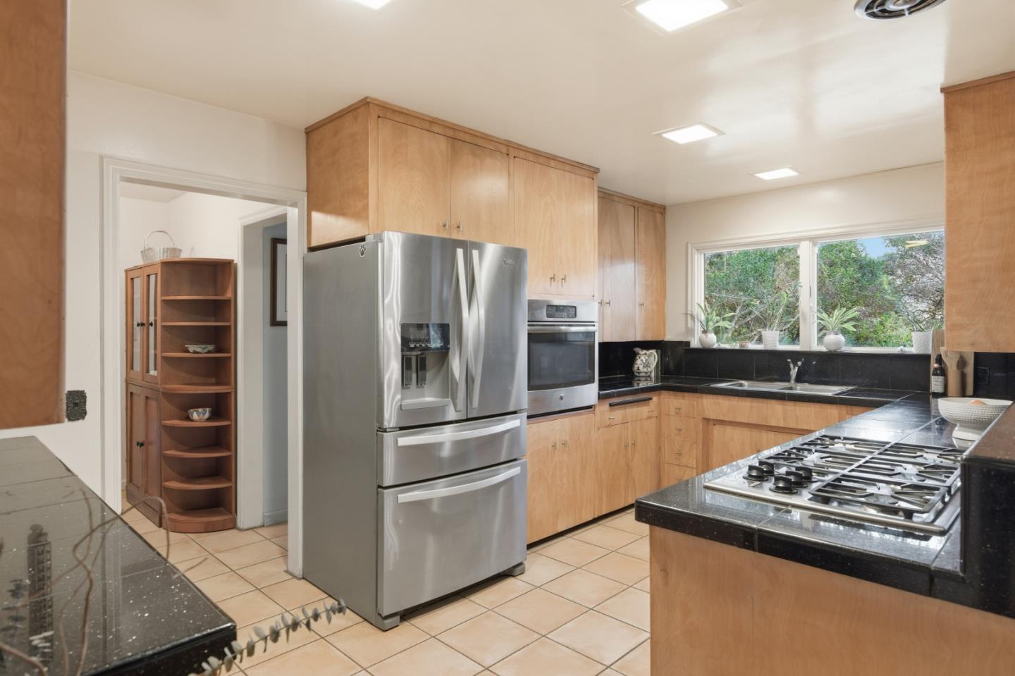 9805 Carmel Valley Road Carmel, CA 93923 - Photo 17 of 35 a kitchen with stainless steel appliances granite countertop a refrigerator stove and oven