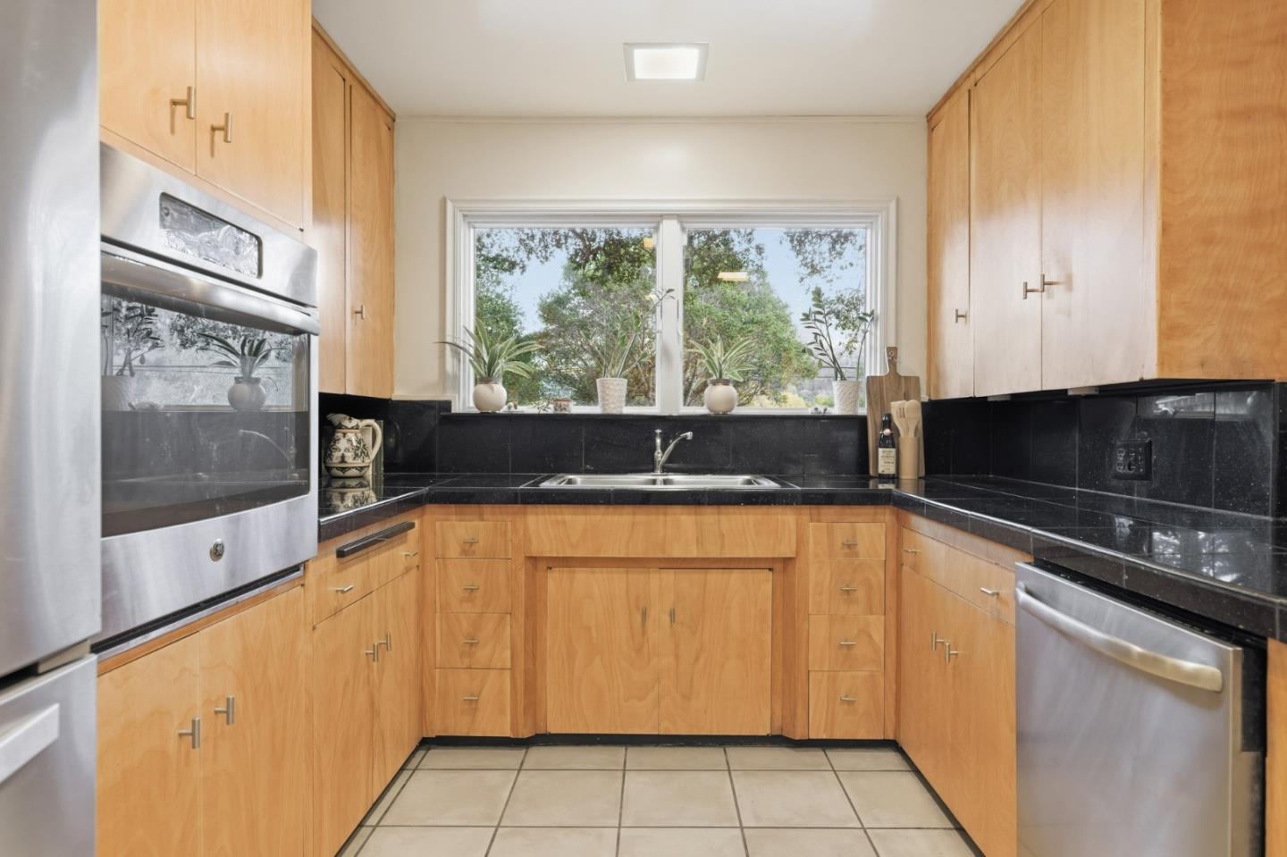 9805 Carmel Valley Road Carmel, CA 93923 - Photo 18 of 35 a kitchen with a large window appliances and cabinets