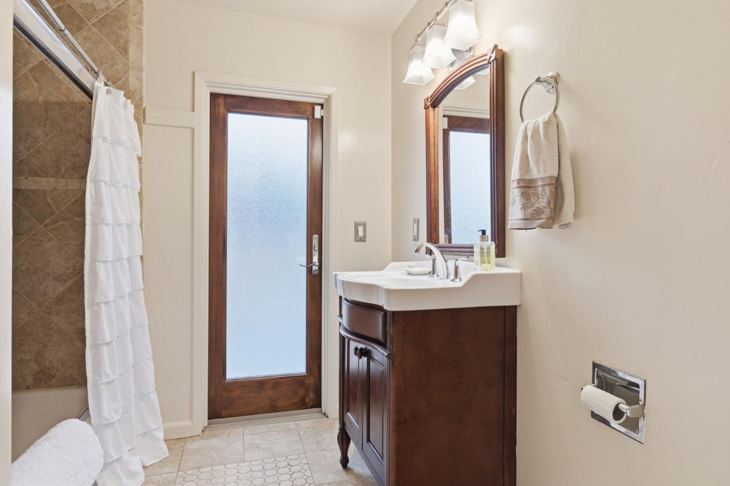 9805 Carmel Valley Road Carmel, CA 93923 - Photo 21 of 35 a bathroom with a double vanity sink and mirror with toilet