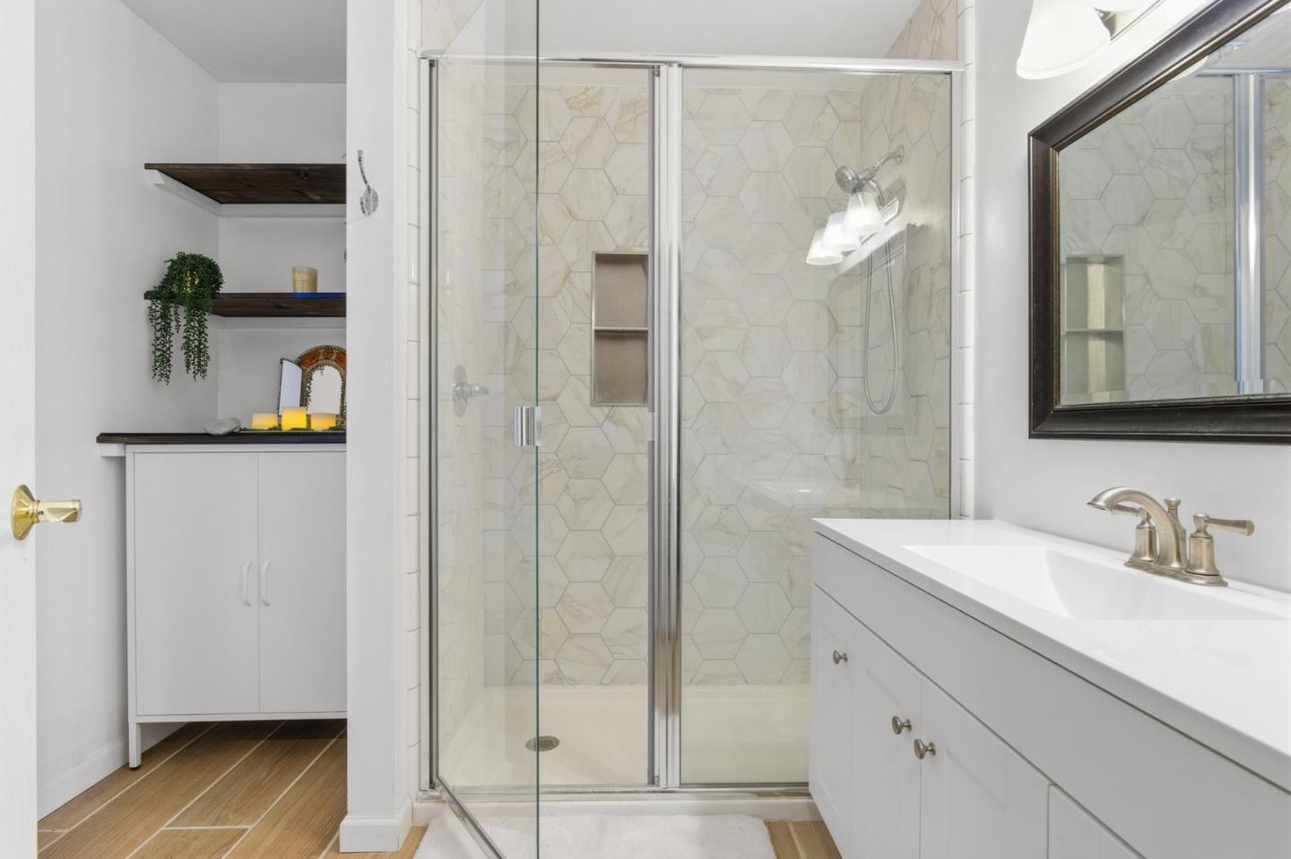 9805 Carmel Valley Road Carmel, CA 93923 - Photo 23 of 35 a bathroom with a shower sink and mirror