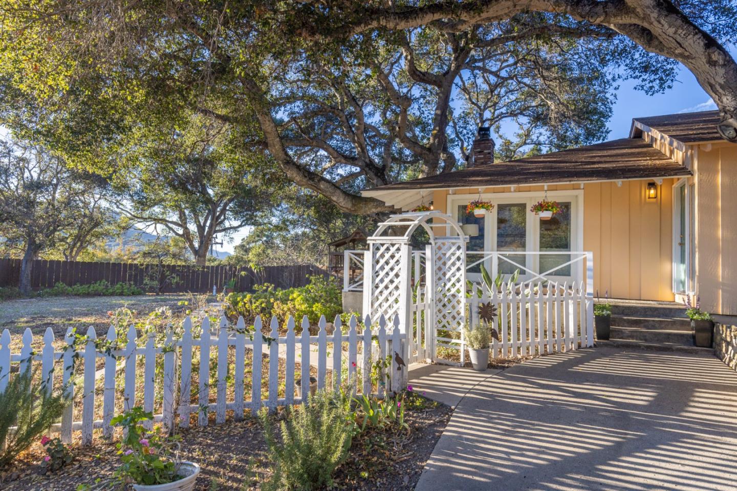 9805 Carmel Valley Road Carmel, CA 93923 - Photo 5 of 35 a front view of a house with a garden