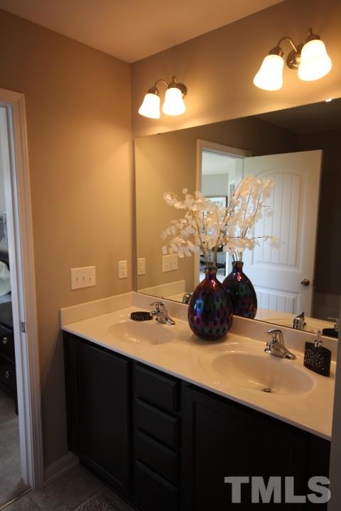 1004 Grand Ridge Drive Rolesville, NC 27571 - Photo 22 of 25 a bathroom with a sink and a mirror