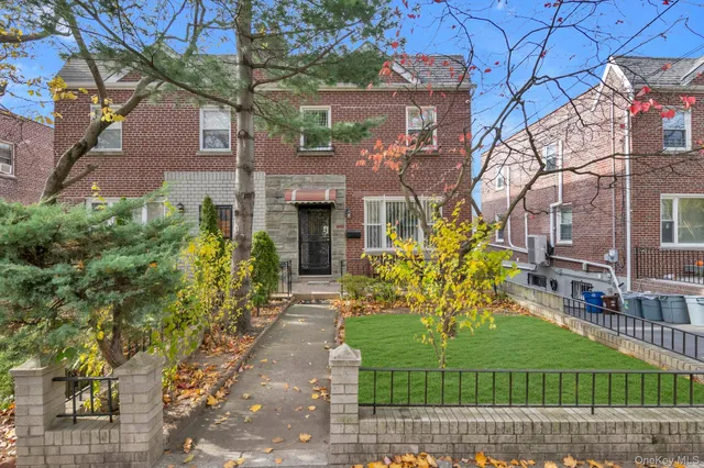 a front view of a house with a garden