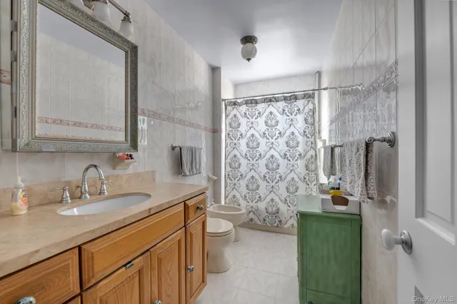 a bathroom with a double vanity sink toilet and shower
