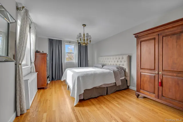 a bedroom with a bed dresser and a window