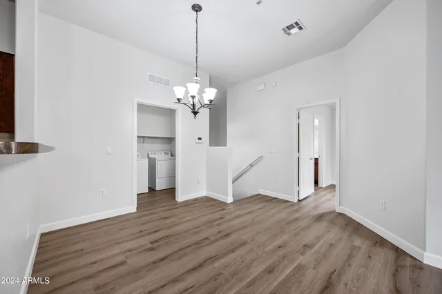 a view of livingroom with chandelier and wooden floor