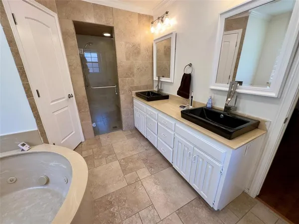 a bathroom with a double vanity sink and a mirror