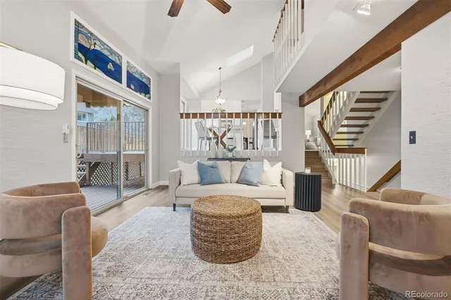 a living room with furniture and a floor to ceiling window