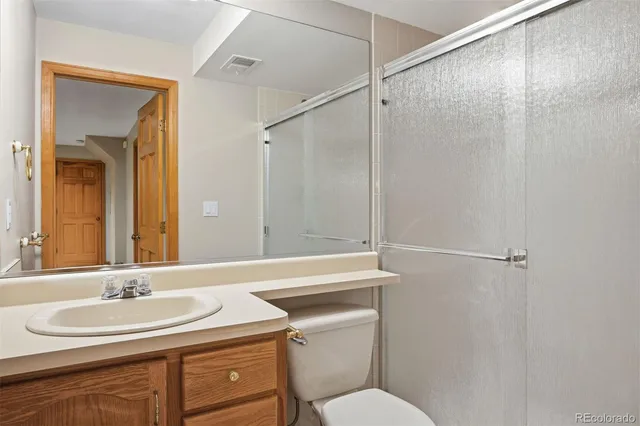 a bathroom with a sink toilet vanity and tub