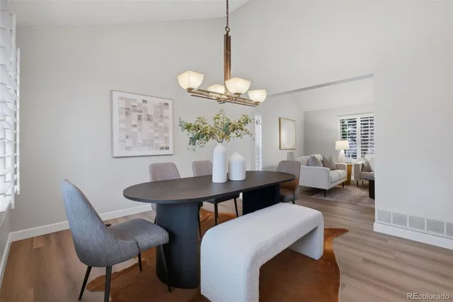 a view of a dining room with furniture window and wooden floor