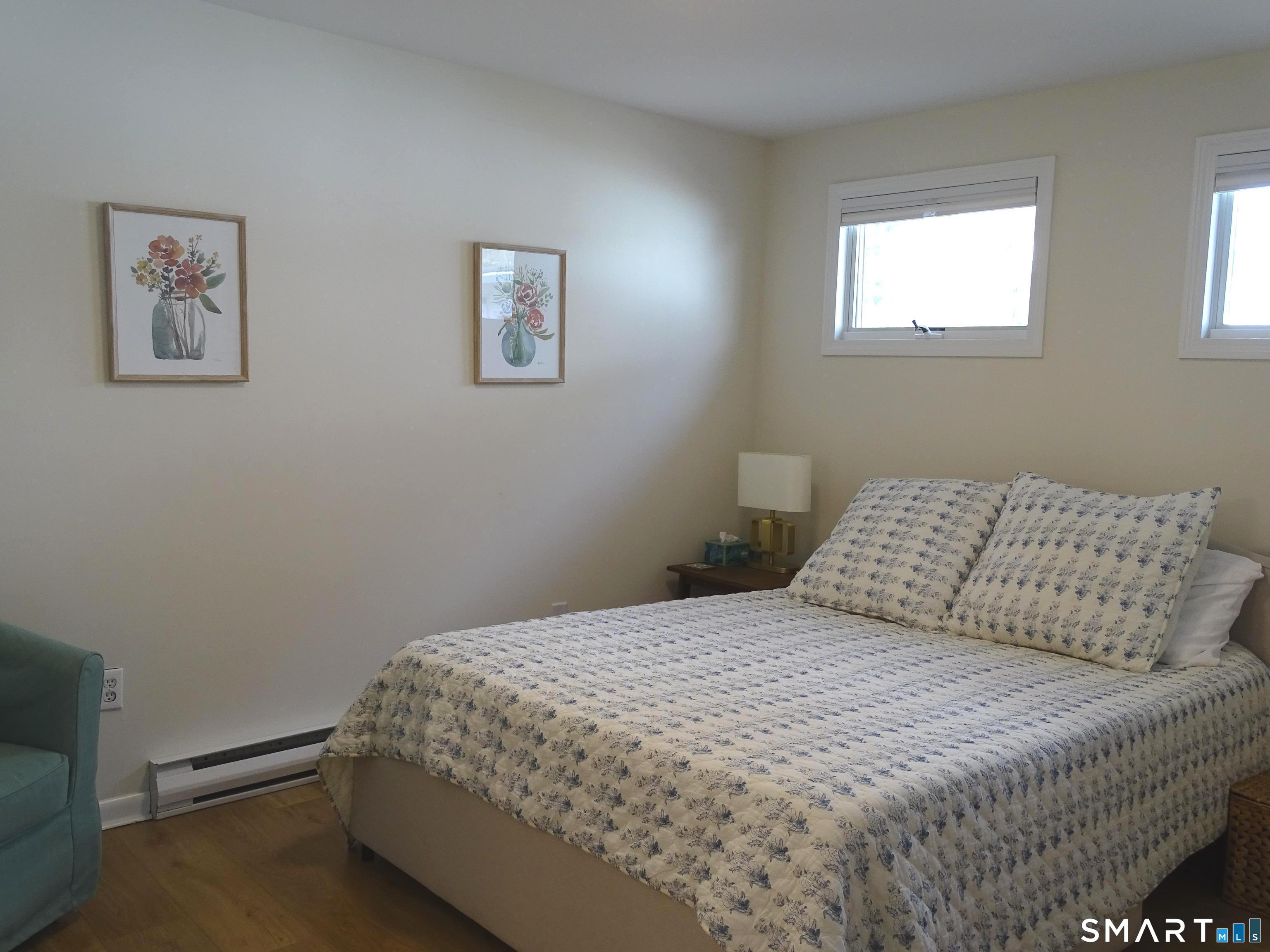 81 Church Street Branford, CT 06405 - Photo 13 of 21 a bedroom with a bed and wall painting