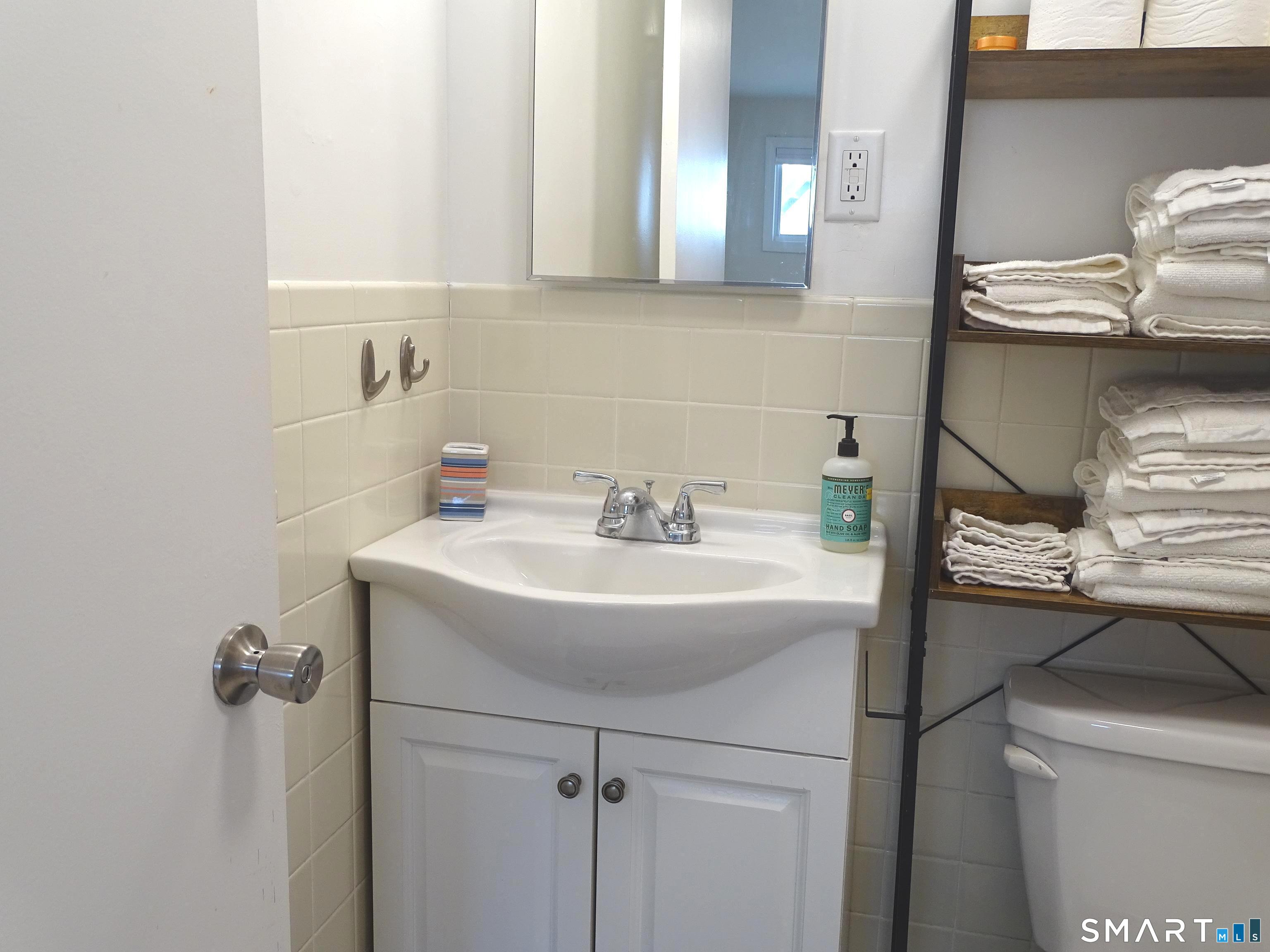 81 Church Street Branford, CT 06405 - Photo 16 of 21 a bathroom with a sink and a toilet