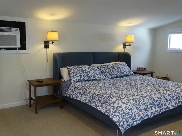 a bedroom with a bed and a night stand