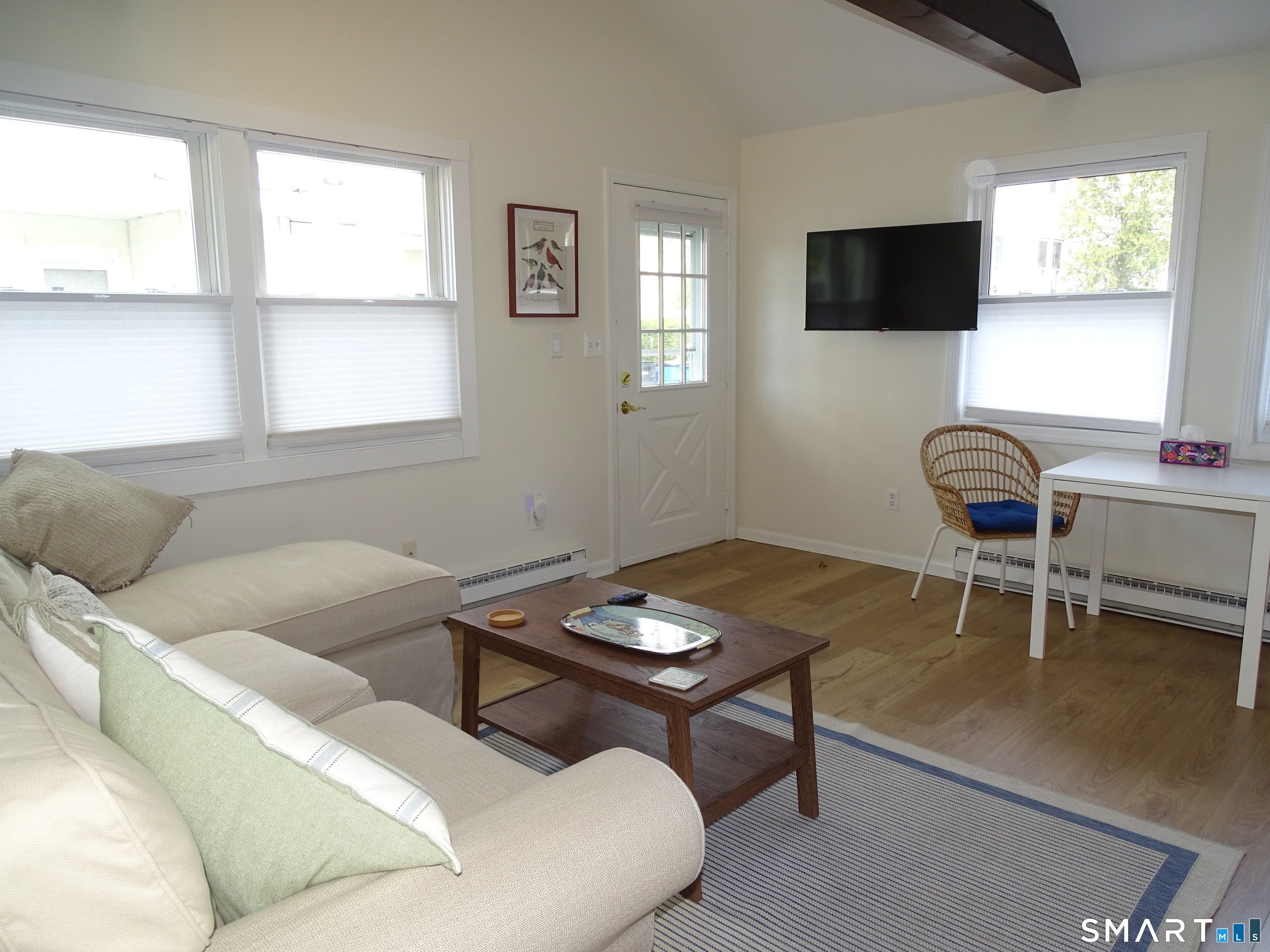 81 Church Street Branford, CT 06405 - Photo 6 of 21 a living room with furniture a flat screen tv and a window